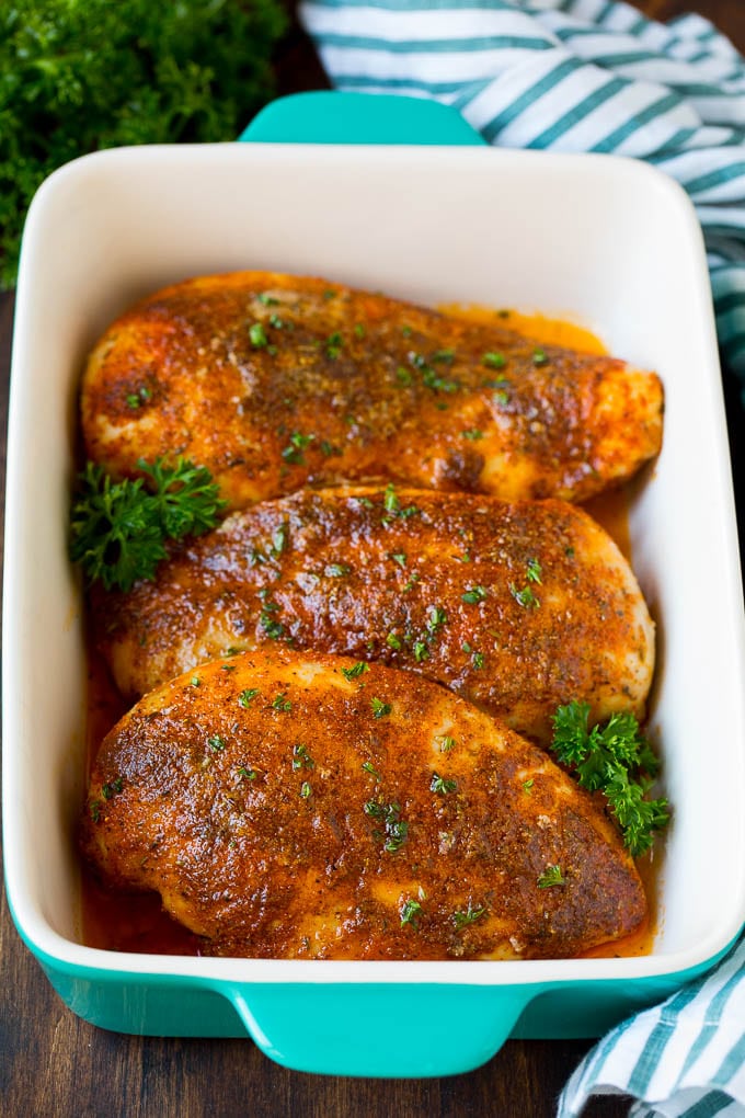 Baked Cajun chicken garnished with fresh parsley.