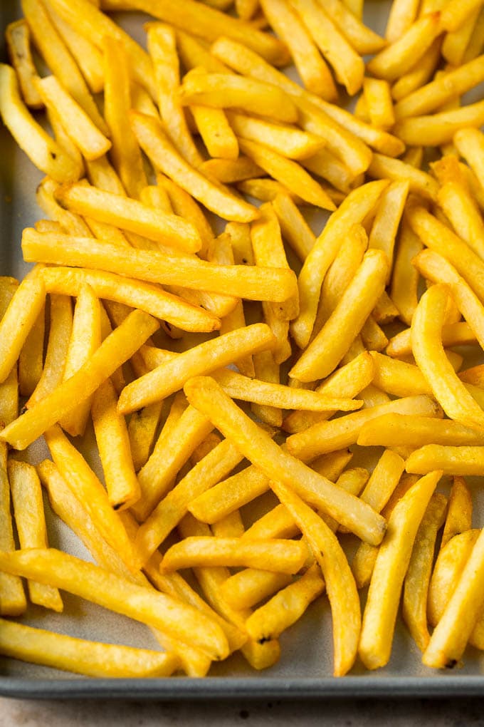 Baked french fries on a sheet pan.