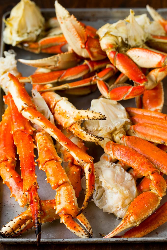 An assortment of different types of crab on a sheet pan.