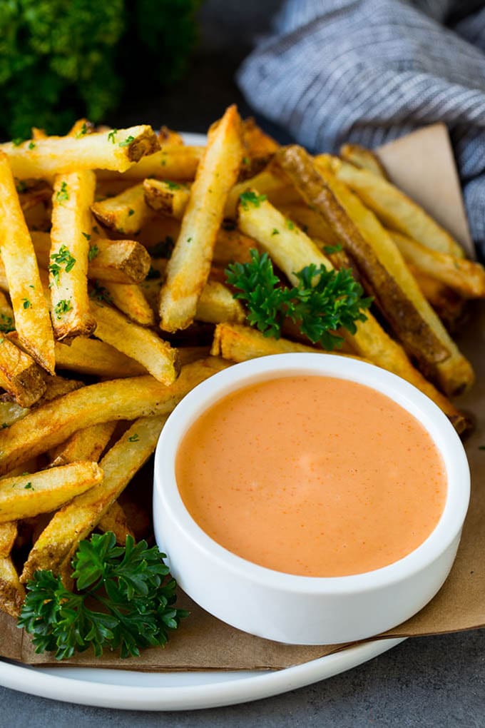 A cup of fry sauce served with homemade french fries.
