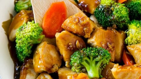 A pan of honey garlic chicken stir fry with a spatula in it.