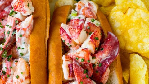 A plate of lobster roll served with chips.