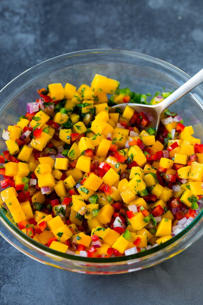 A mixture of fresh mango, cilantro, bell pepper and jalapeno.