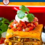 This Mexican lasagna is layers of flour tortillas, cheese, beans and ground beef, all baked together until golden brown.
