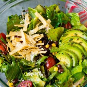 Mexican salad with lettuce, corn, beans and tomato, tossed in a lime dressing.