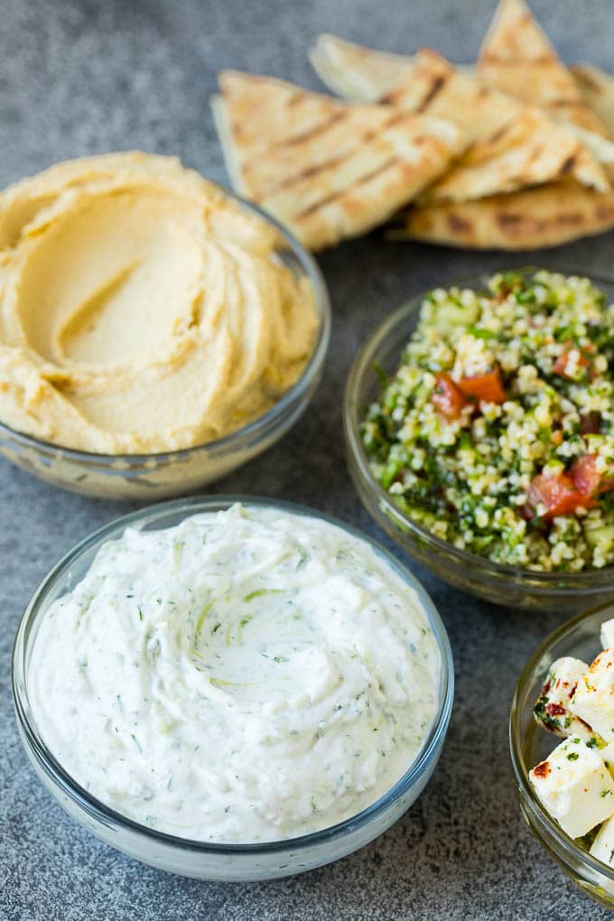 Bowls of hummus, tzatziki and tabbouleh.