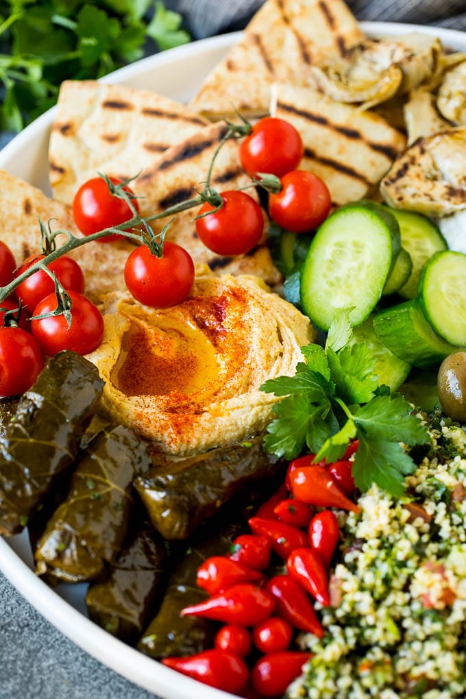 A Mediterranean mezze platter with hummus, dolmas and vegetables.