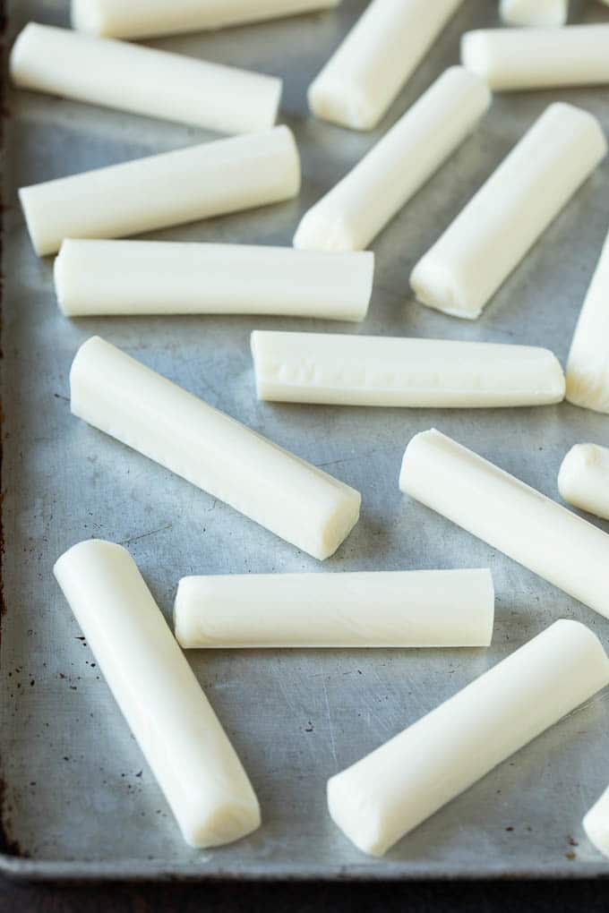 Cheese sticks on a sheet pan.