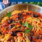 This pasta puttanesca is spaghetti tossed in a homemade tomato sauce that is flavored with olives, capers and herbs.
