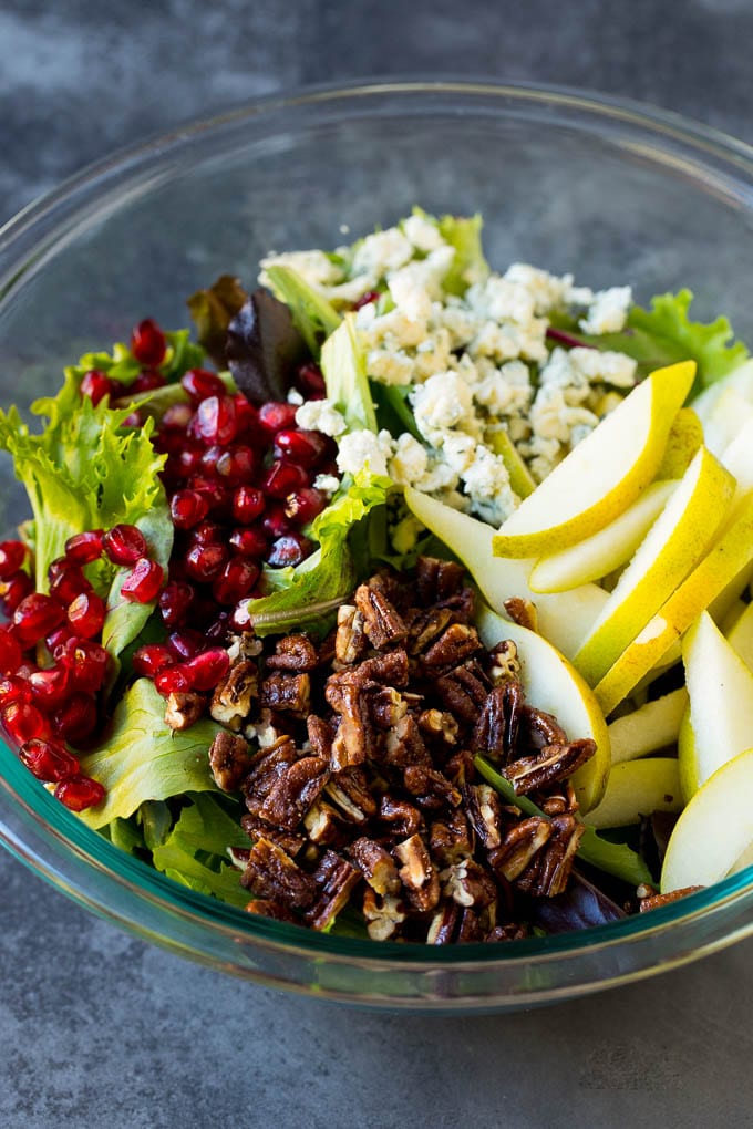 Lettuce with sliced pears, blue cheese and pecans on top.