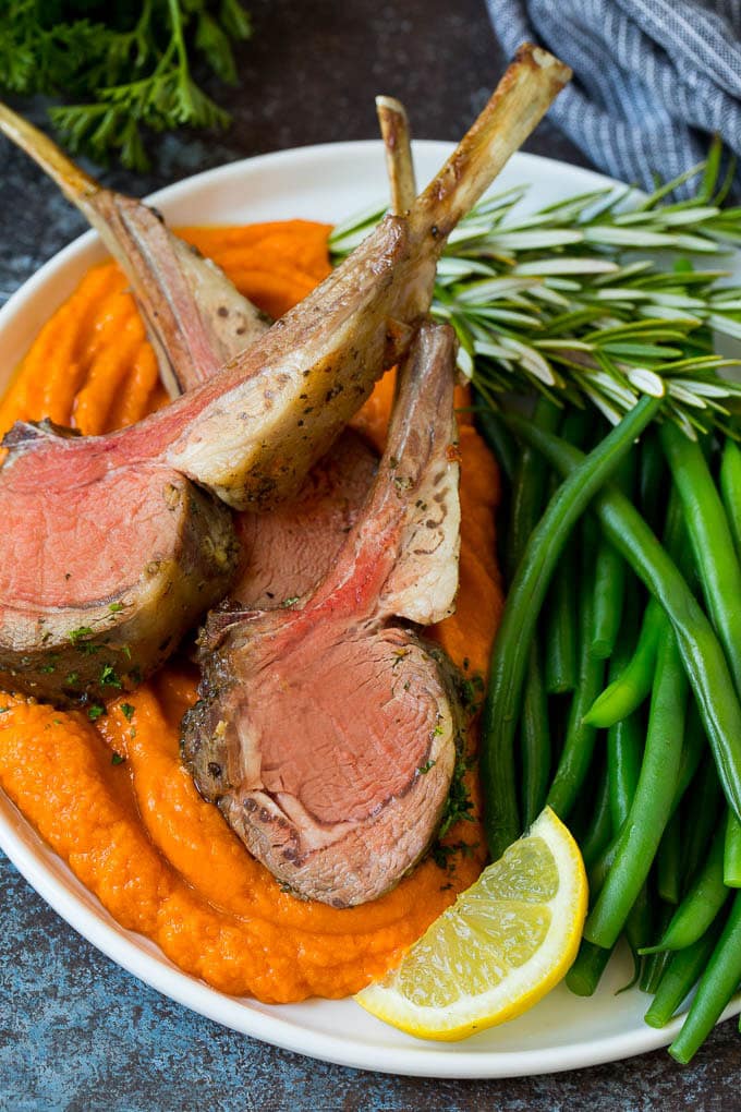 Rack of lamb served with sweet potatoes and green beans.