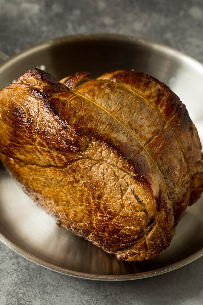 A browned chuck roast in a pan.