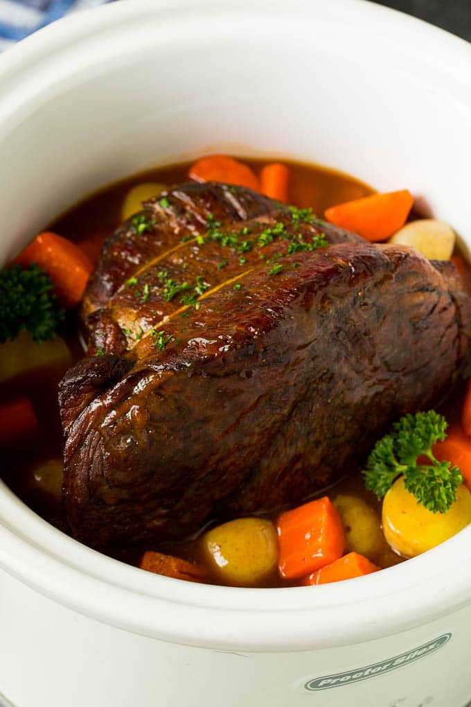 Slow cooker pot roast with carrots, potatoes and gravy.