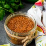 A jar of taco seasoning with a savory blend of spices.