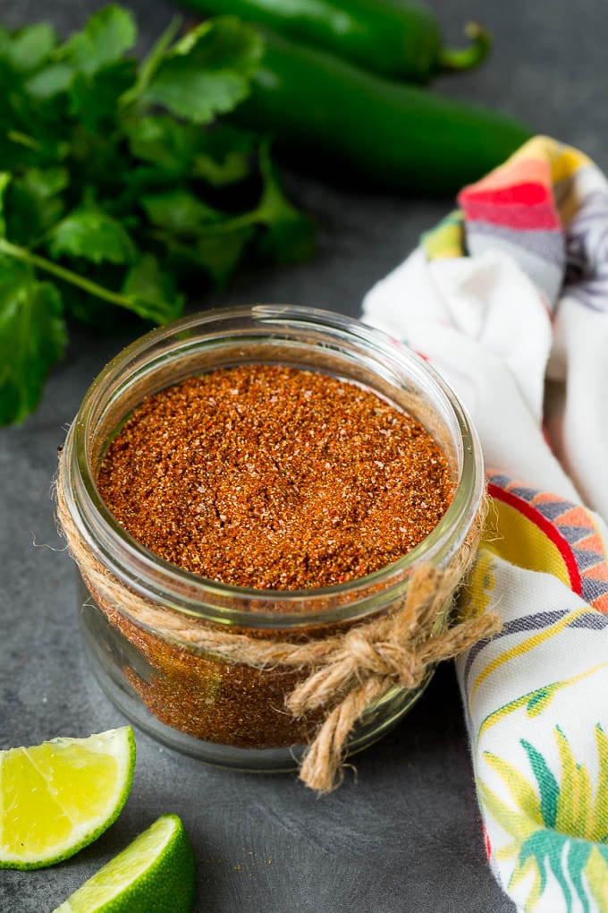 A jar of taco seasoning with a savory blend of spices.