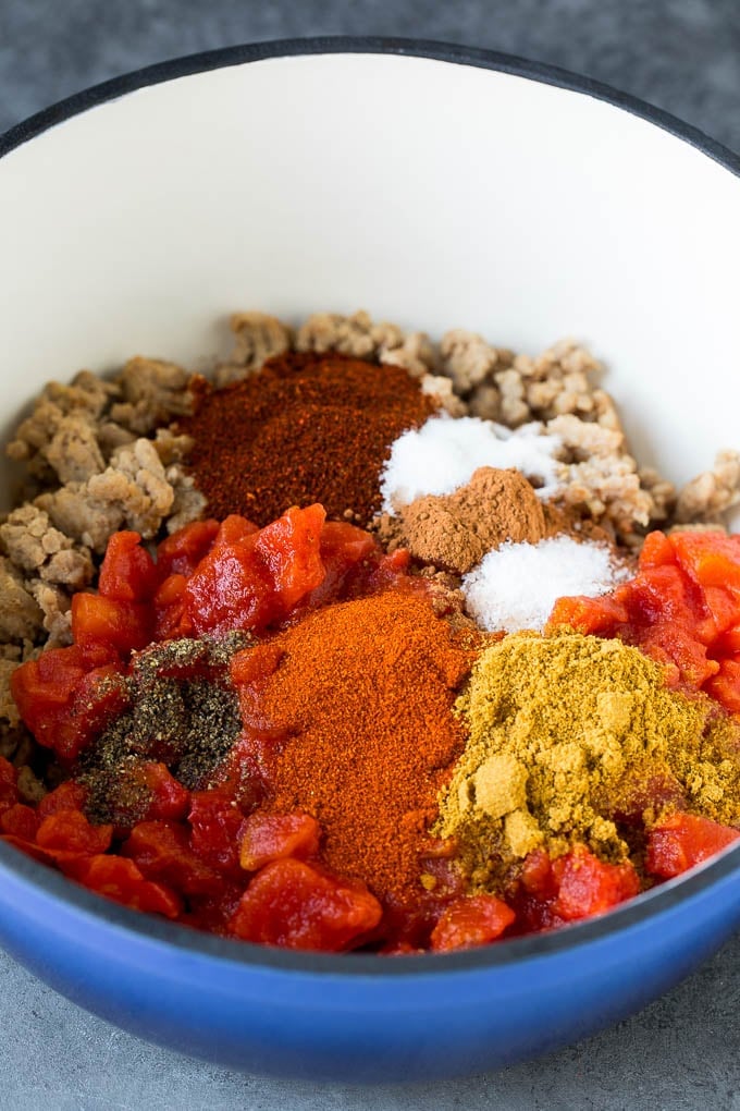 Ground turkey, spices and tomatoes in a soup pot.