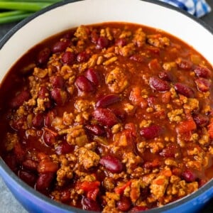 A pot of turkey chili served with cornbread.