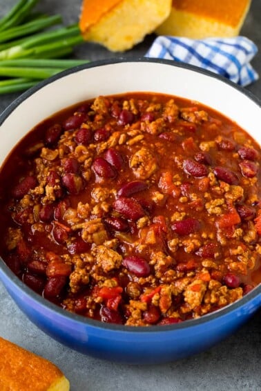 A pot of turkey chili served with cornbread.