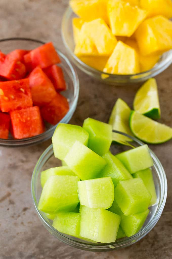 Bowls of cubed melon and pineapple.
