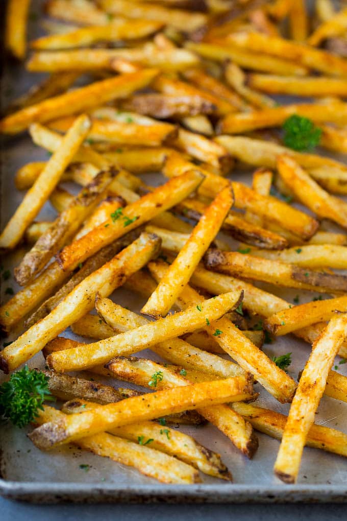 Baked french fries on a sheet pan.