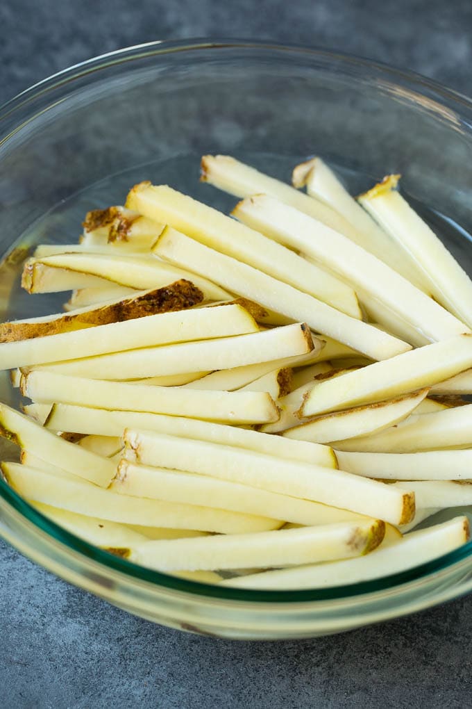 Potato matchsticks in a bowl of water.