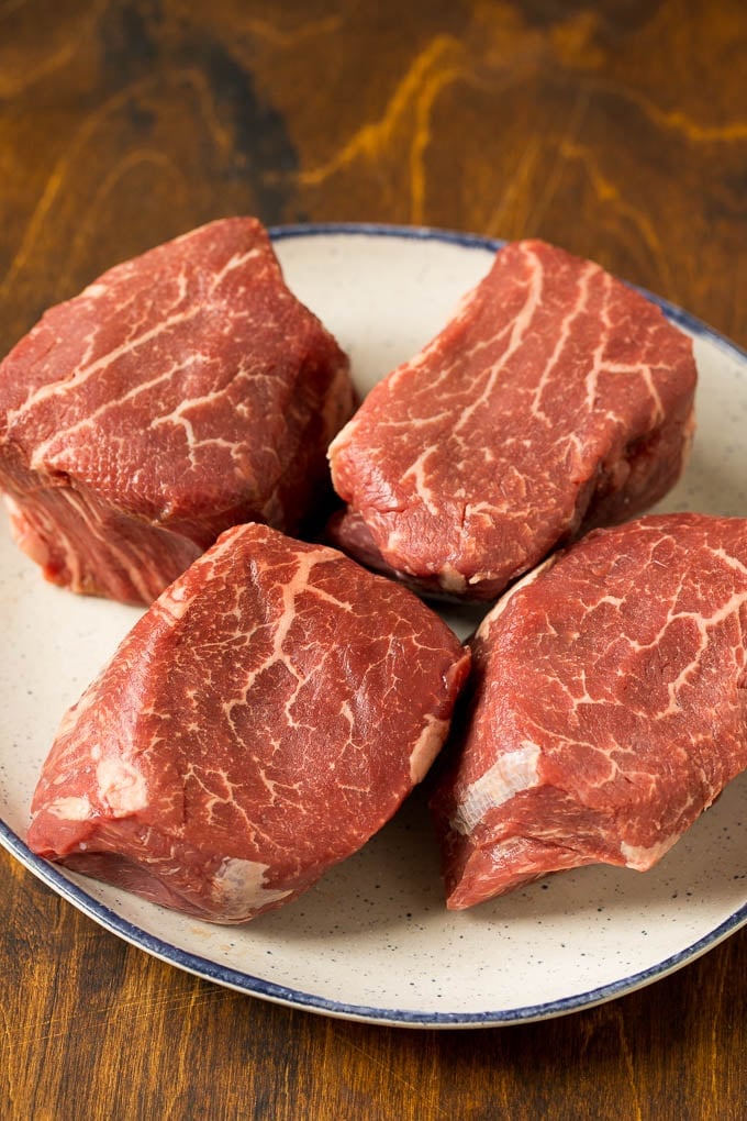 Raw steaks on a plate.