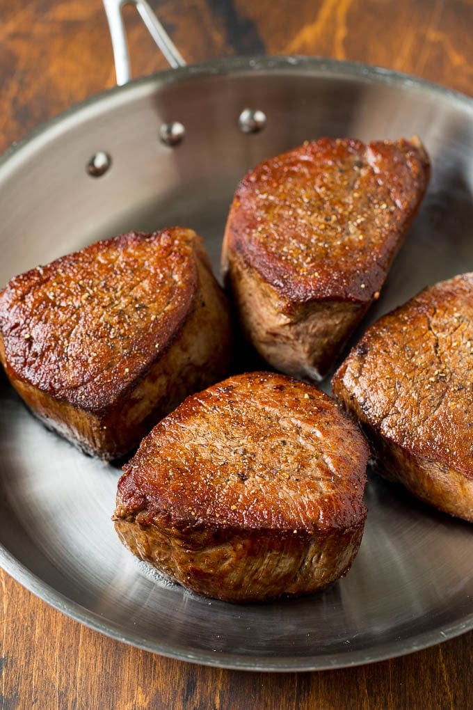 Steaks seared in a skillet.