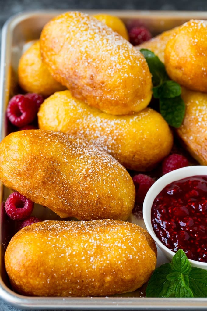 A tray of fried Twinkies topped with powdered sugar.