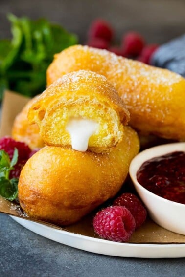 A plate of fried Twinkies served with raspberry sauce.