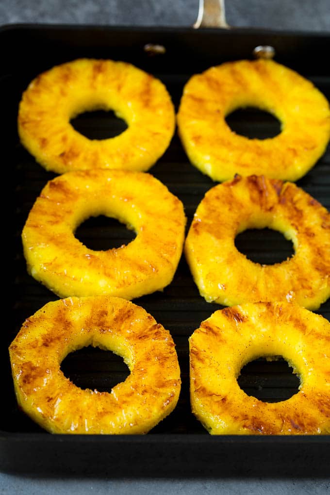 Cooked pineapple on a grill pan.