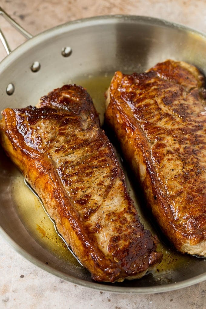 Seared steaks in a skillet.