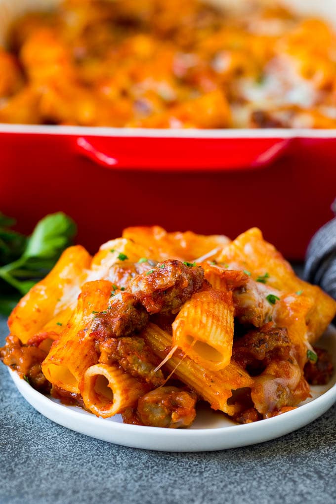 A plate of Pasta al Forno topped with melted cheese and parsley.