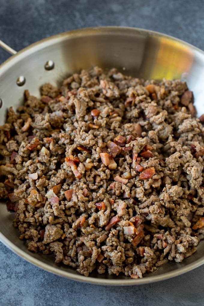 Ground beef and pancetta cooked in a pan.