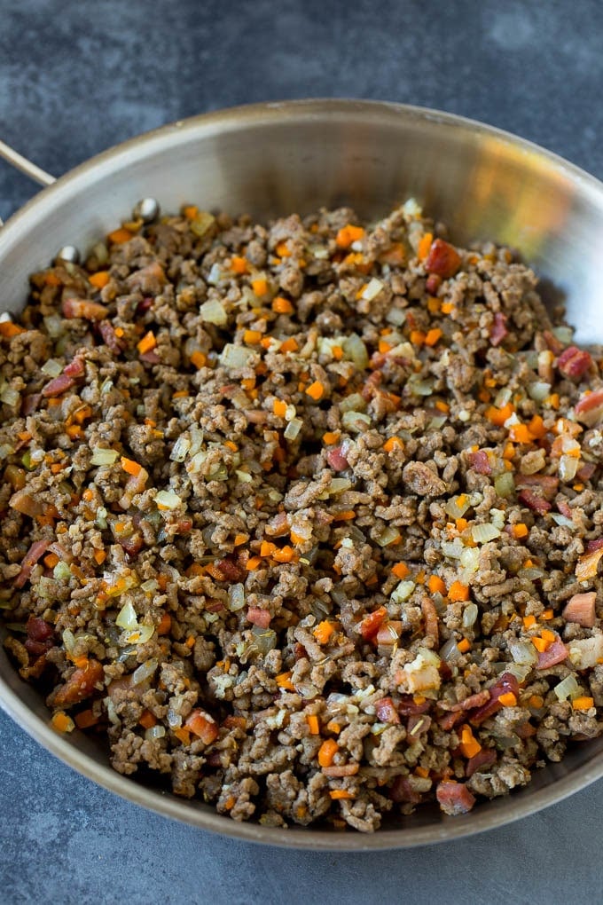 Meat and diced vegetables cooked together in a pan.