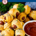 Pigs in a blanket is a classic party snack made with cocktail wieners wrapped in crescent dough, which are baked to golden brown perfection.