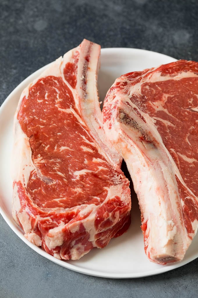 Raw steaks on a plate.