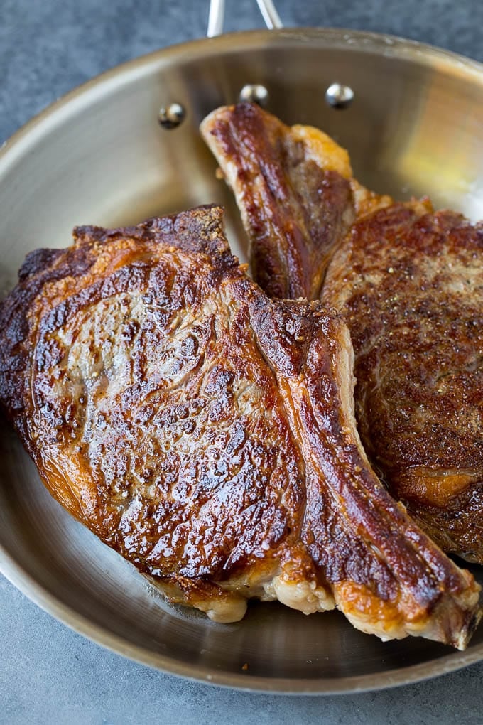 Seared steaks in a skillet.