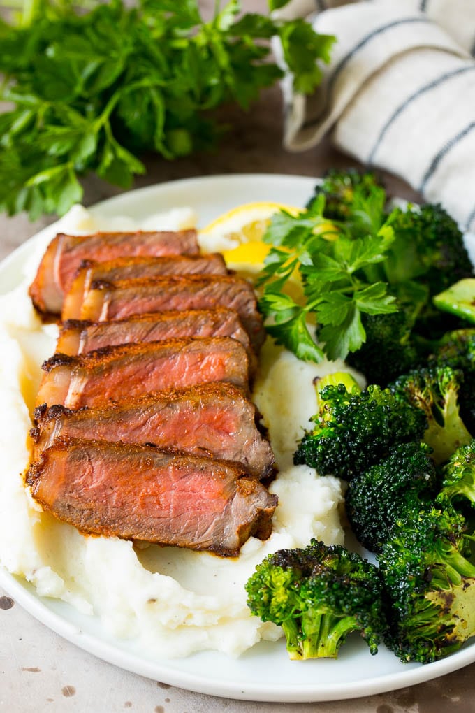 Steaks coated with steak seasoning, then sliced and served over mashed potatoes.