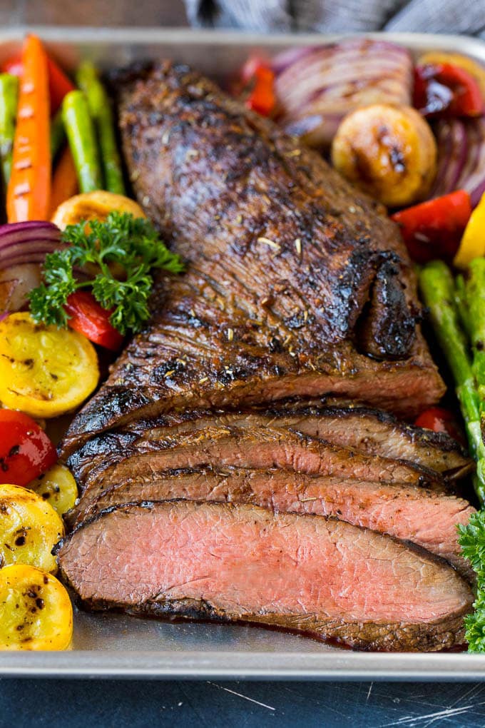 Meat cooked in tri tip marinade sliced and served with grilled vegetables.