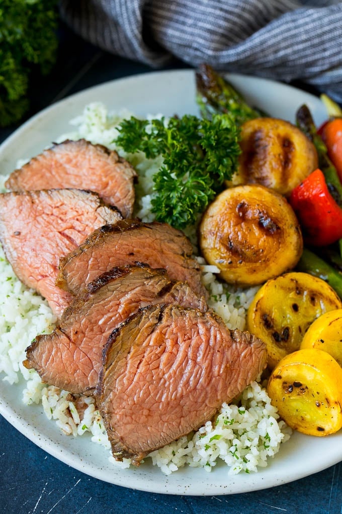 Sliced meat cooked in tri tip marinade over rice with vegetables.