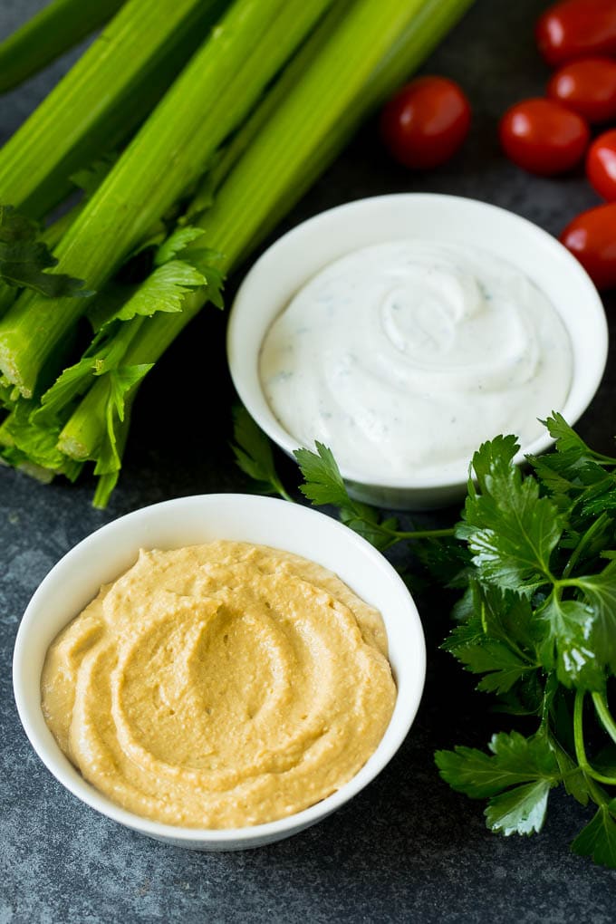 Bowls of hummus and ranch dip.