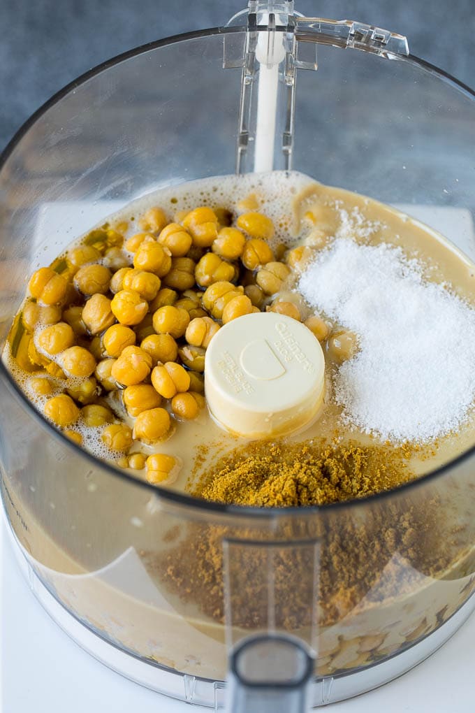 Chickpeas, tahini and spices in a food processor.