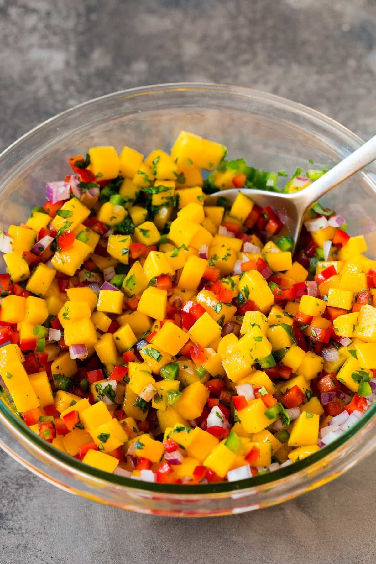 A bowl of diced mango and vegetables.