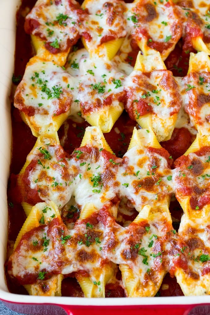 Baked stuffed shells filled with three types of cheese and topped with marinara sauce. #pasta #dinneratthezoo Baked stuffed shells filled with three types of cheese and topped with marinara sauce.