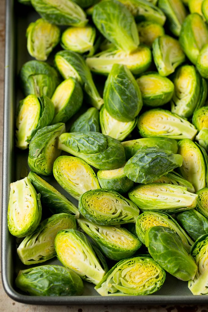 Halved sprouts on a sheet pan.