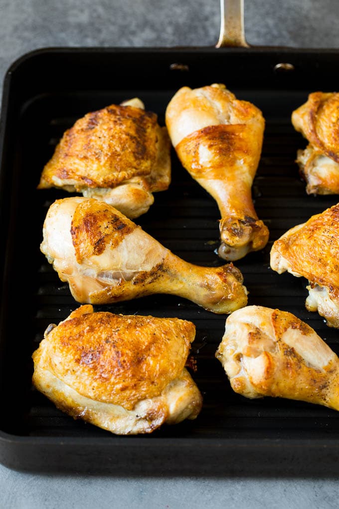 Chicken thighs and drumsticks on a grill pan.