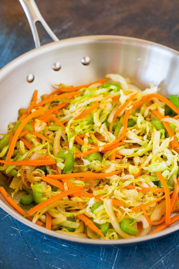 Carrots, celery and cabbage cooked in a pan.