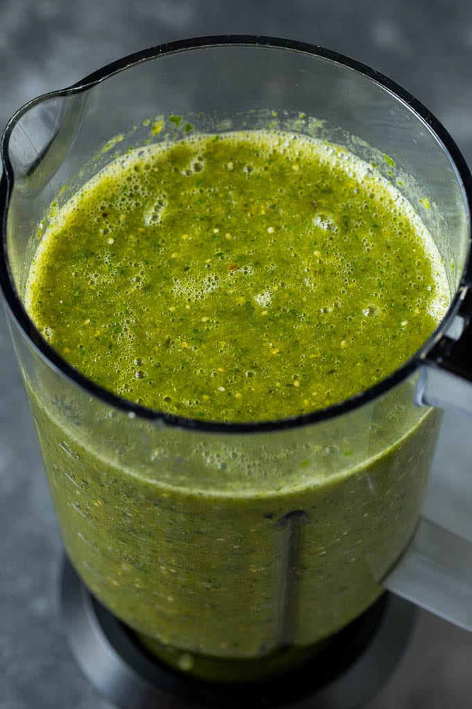 A puree of tomatillos, chiles and cilantro in a blender.