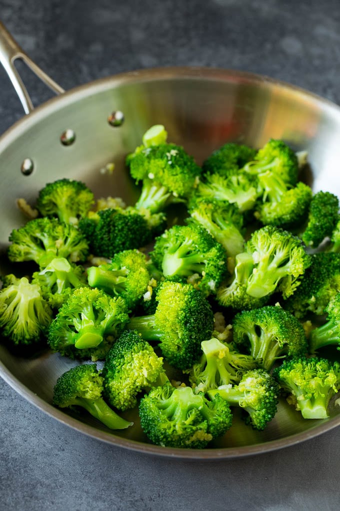Cooked broccoli florets in a pan.