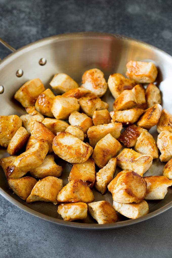 Seared chicken breast in a pan.